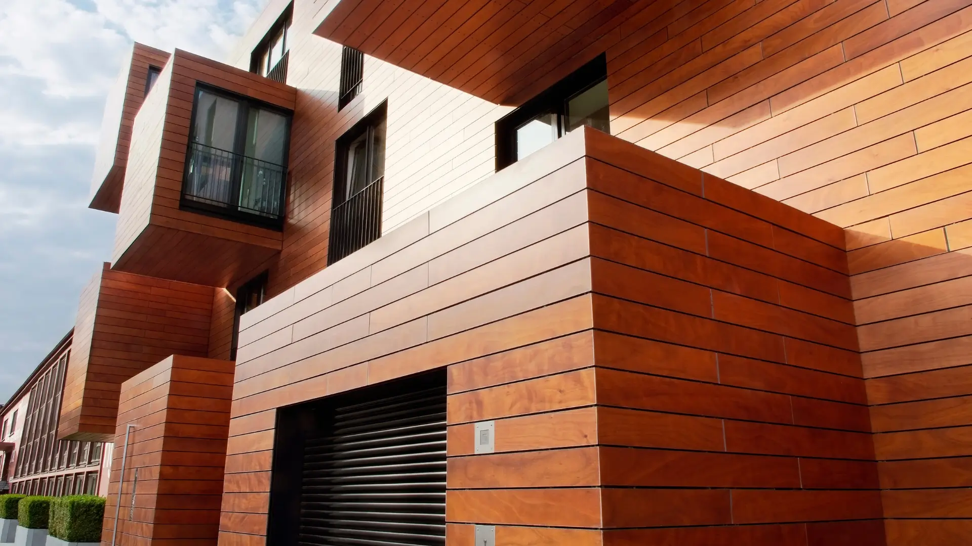 Timber look exterior wall finish on a modern building showing full reclad work for Recladding Matakana.